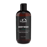 A bottle of Mountaineer Brand Products Natural Men's Body Wash labeled "timber" with cedar, fir, and eucalyptus scents, 12 fl oz (355 ml).
