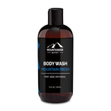 A bottle of Mountaineer Brand Products men's natural body wash labeled "mountain fresh" with mint, sage, and patchouli, 12 fl oz size.