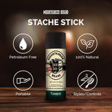 An all-natural and organic Mustache Wax - 9 Scents Available proudly displayed on a wooden table by Mountaineer Brand Products.